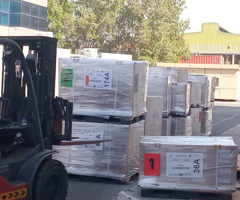 A forklift placing the last pallets for loading