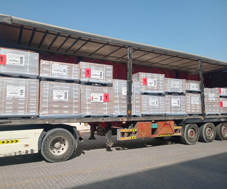 A loaded trailer of palletised ballot material on the way to the aircraft
